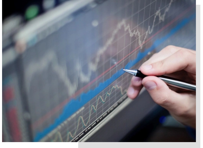 A person holding a pen and writing on a screen.