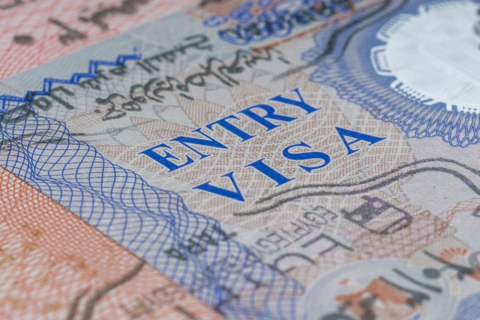 A close up of the entry visa on top of a passport.